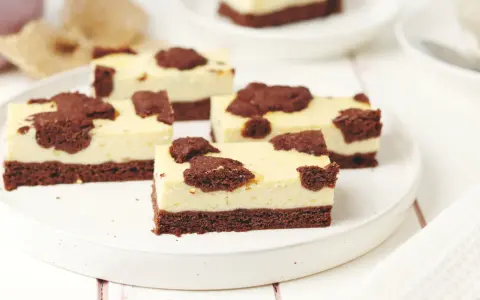 Saftiger russischer Zupfkuchen vom Blech, in Stücke geschnitten, mit Schokoladenstückchen auf cremiger Käsemasse.
