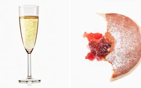 Sektglas mit Bläschen und ein angebissener Krapfen mit Marmelade. Wein Kalorien sind oft unterschätzt.