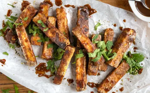 Marinierter Tofu, knusprig gebraten und mit frischem Koriander und einer dunklen Sauce garniert. Perfekt zum **Tofu marinieren** und Genießen.