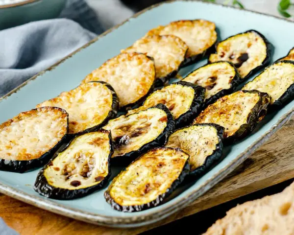 Gegrillte Zucchinischeiben mit Käse, ein schnelles Backofen-Rezept. Perfekt als Beilage oder leichtes Hauptgericht.