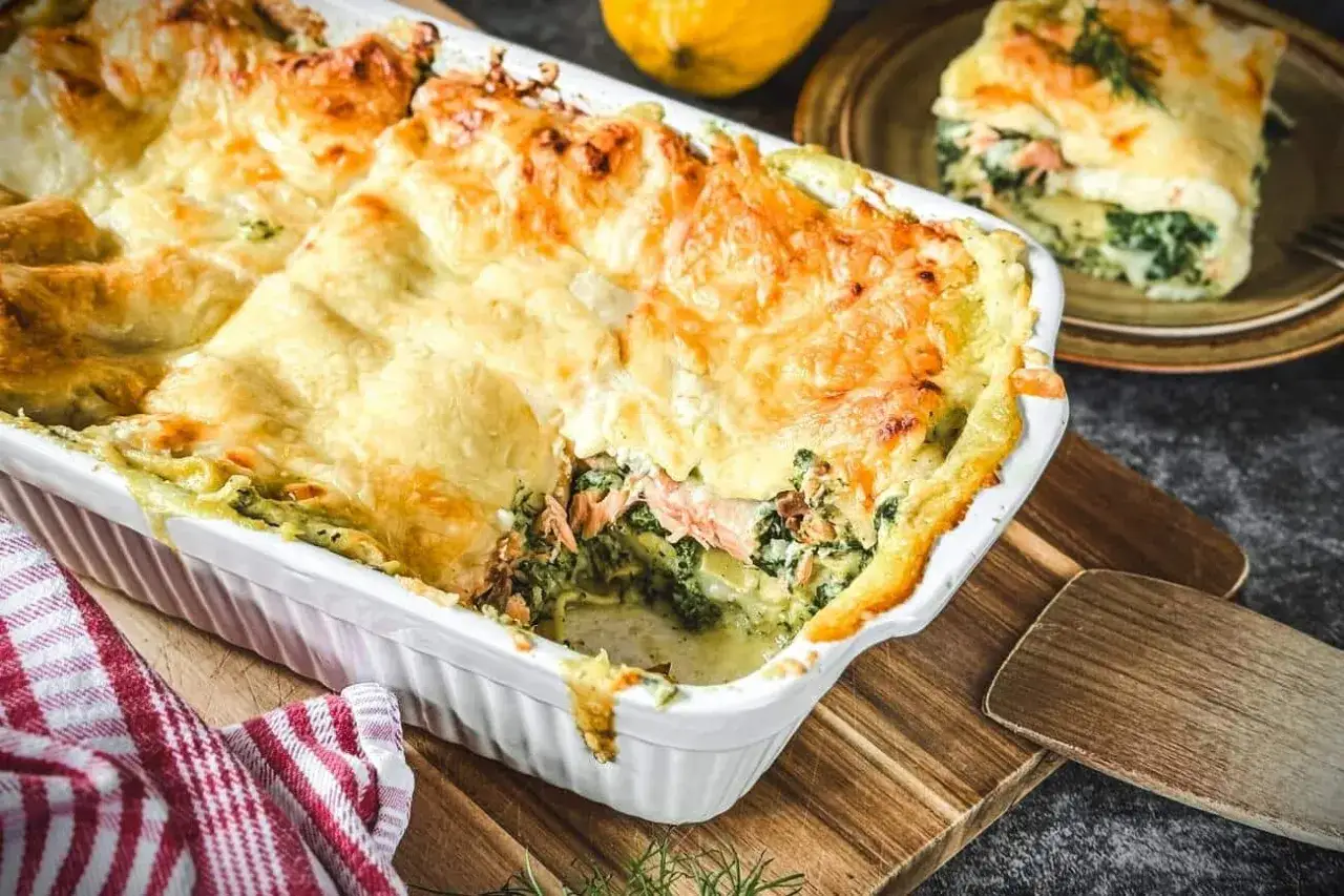 Herzhafte Lachs Spinat Lasagne mit goldbraun überbackener Käseschicht, bereit zum Servieren.